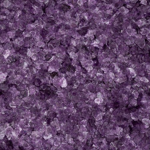 A close-up view of numerous small, polished, deep purple amethyst crystals clustered together.