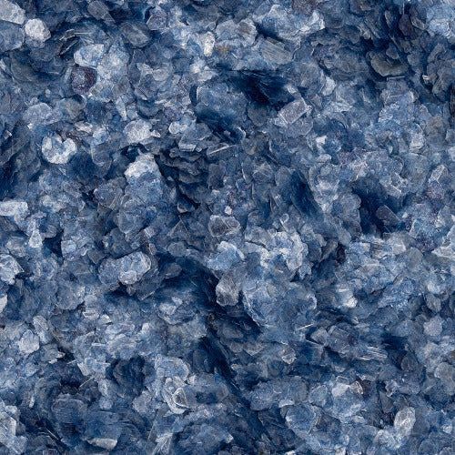 A close-up of dark and light blue, crystalline, translucent glass fragments in varying shades and sizes.