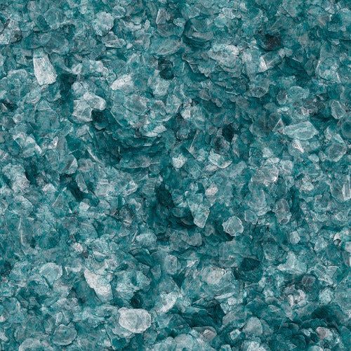 A close-up of coarse, translucent teal-colored crystals or crushed glass fragments with varied shapes and textures.