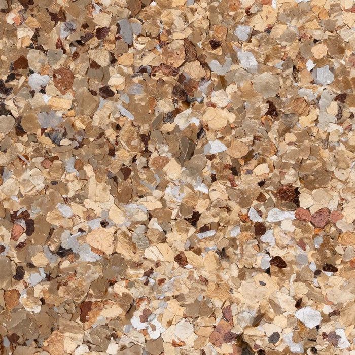 A dense, textured pattern of small, multi-colored stone chips in shades of tan, brown, beige, and white.