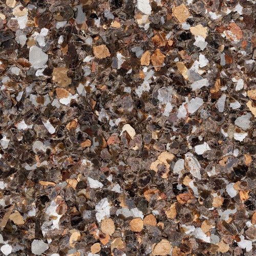 A close-up texture of decorative epoxy flooring flakes in shades of dark brown, beige, cream, and white.