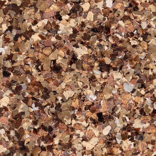 A close-up texture of multi-sized, overlapping decorative floor flakes in shades of tan, brown, bronze, and cream.