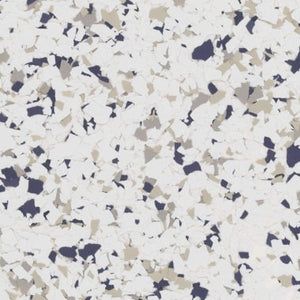 A white floor surface featuring a scattered, speckled pattern of small dark navy and light tan flakes.