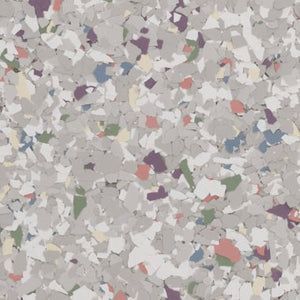 A grey-toned epoxy floor texture with scattered colorful vinyl chips in shades of blue, green, orange, and purple.