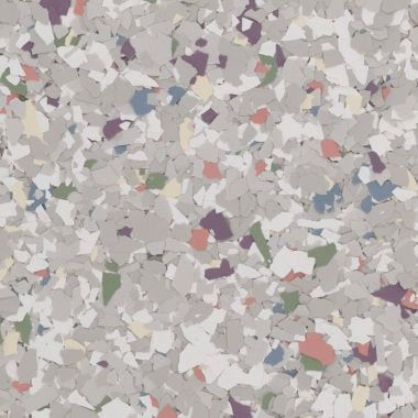 A textured surface with scattered grey, white, green, blue, purple, and coral-colored paint flakes or flecks.