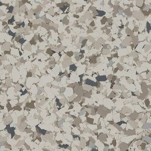 Decorative epoxy flooring finish with a speckled, multicolored pattern of beige, tan, gray, and dark charcoal flakes.