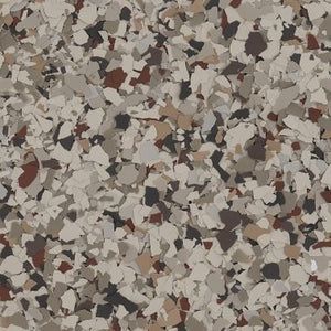 A close-up of a decorative flooring finish featuring a dense blend of tan, brown, black, and light gray vinyl color chips.