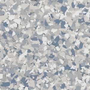 A close-up of a decorative flooring finish featuring a mix of white, light gray, and blue vinyl flakes.