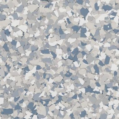 A close-up of a decorative flooring finish featuring a dense blend of blue, grey, and white paint flakes.