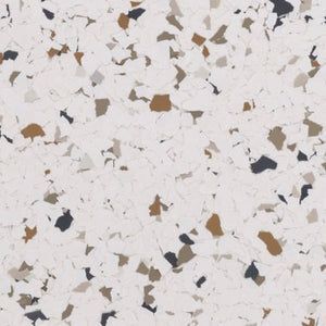 A white background with a scattered pattern of small, irregularly shaped flecks in shades of brown, tan, and dark gray.