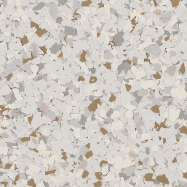 Epoxy floor flakes in a mix of white, light gray, and tan speckles over a neutral base.