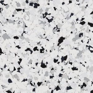 A floor surface covered in a speckled pattern of white, grey, and black flakes.