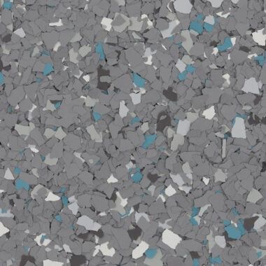 A close-up of speckled flooring with grey, white, and blue vinyl chips embedded in a neutral base.