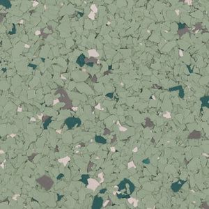 A close-up view of sage green epoxy flooring with flecks of dark green, grey, and white paint chips.
