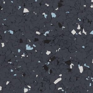 A textured, dark grey rubber flooring surface speckled with small white and light blue flecks.
