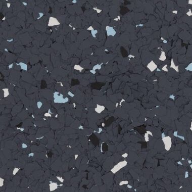 Dark gray epoxy floor coating with scattered white and light blue vinyl flake chips.