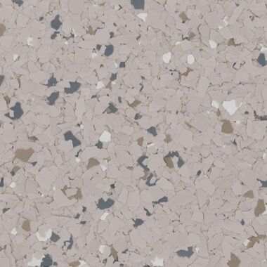 A beige-toned vinyl floor texture featuring a speckled pattern of small, irregularly shaped gray, white, and brown flakes.
