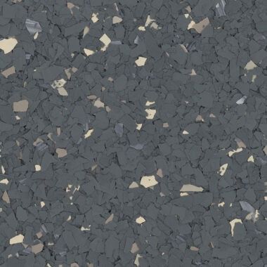 Dark grey flooring material with a textured, speckled finish featuring small, irregular light grey and white accents.