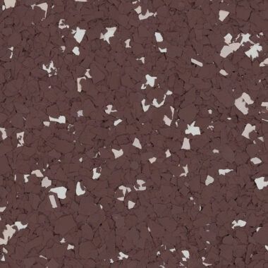 A close-up of dark brown rubber flooring speckled with small, irregular cream-colored flecks.
