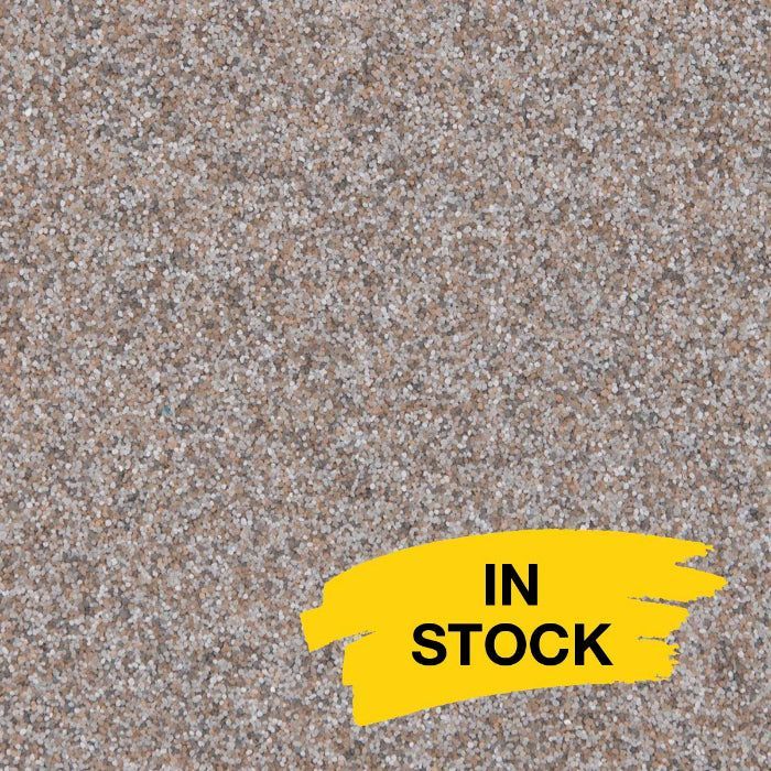 A textured, speckled granite surface in shades of brown and grey, with a yellow graphic in the corner reading 