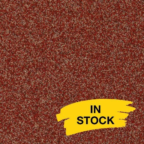 A close-up of a speckled red and tan carpet texture with a yellow 