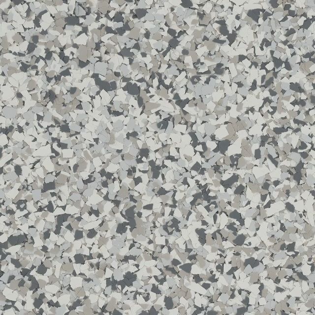 A close-up of a mottled floor surface with a speckled pattern of grey, white, and charcoal flakes.
