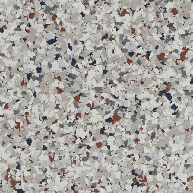 A multi-colored epoxy floor texture with flecks of white, gray, black, and reddish-brown.