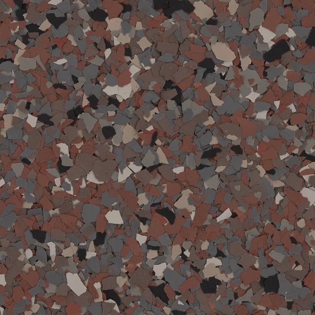 Close-up of a decorative flooring finish with an irregular, speckled pattern of rust, gray, tan, and black flakes.