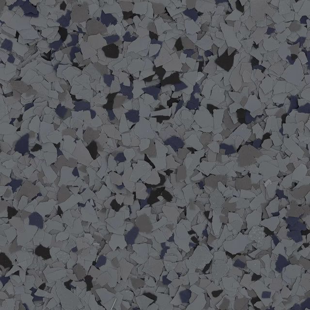 Close-up of a decorative epoxy floor finish with a speckled pattern of blue, black, white, and gray vinyl flakes.