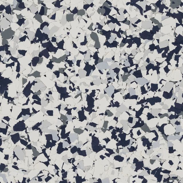 A decorative flooring texture featuring a multi-colored pattern of white, gray, and dark navy blue paint chips.