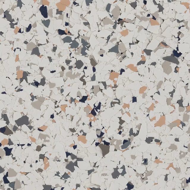 A close-up of a decorative epoxy floor coating with a mix of white, grey, black, and tan flecks on a white background.