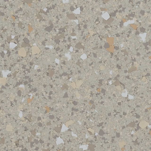 A neutral beige floor surface featuring a multi-colored speckled pattern of tan, brown, white, and grey vinyl flakes.