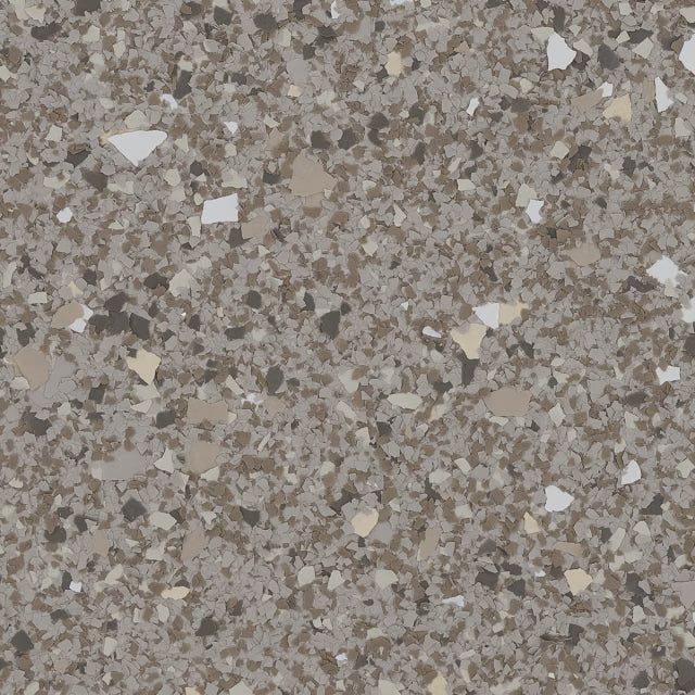 A close-up texture of gray, beige, and white speckled flooring flakes, often used for garage or industrial concrete.