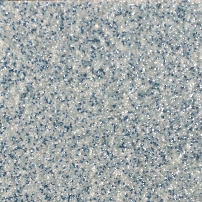 A close-up of a textured surface featuring a speckled pattern of small, light gray and dark blue grains.