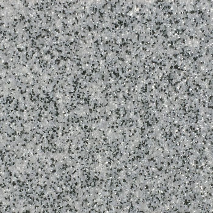 A close-up view of a light gray speckled granite or stone surface with a uniform, textured pattern of dark flecks.