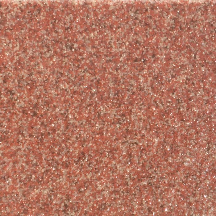 A close-up, top-down view of a textured, reddish-brown abrasive surface, resembling fine-grit sandpaper.