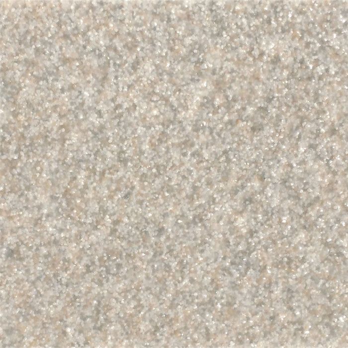 A close-up, textured surface showing a granular, light beige or sand-colored pattern with tiny, reflective particles.