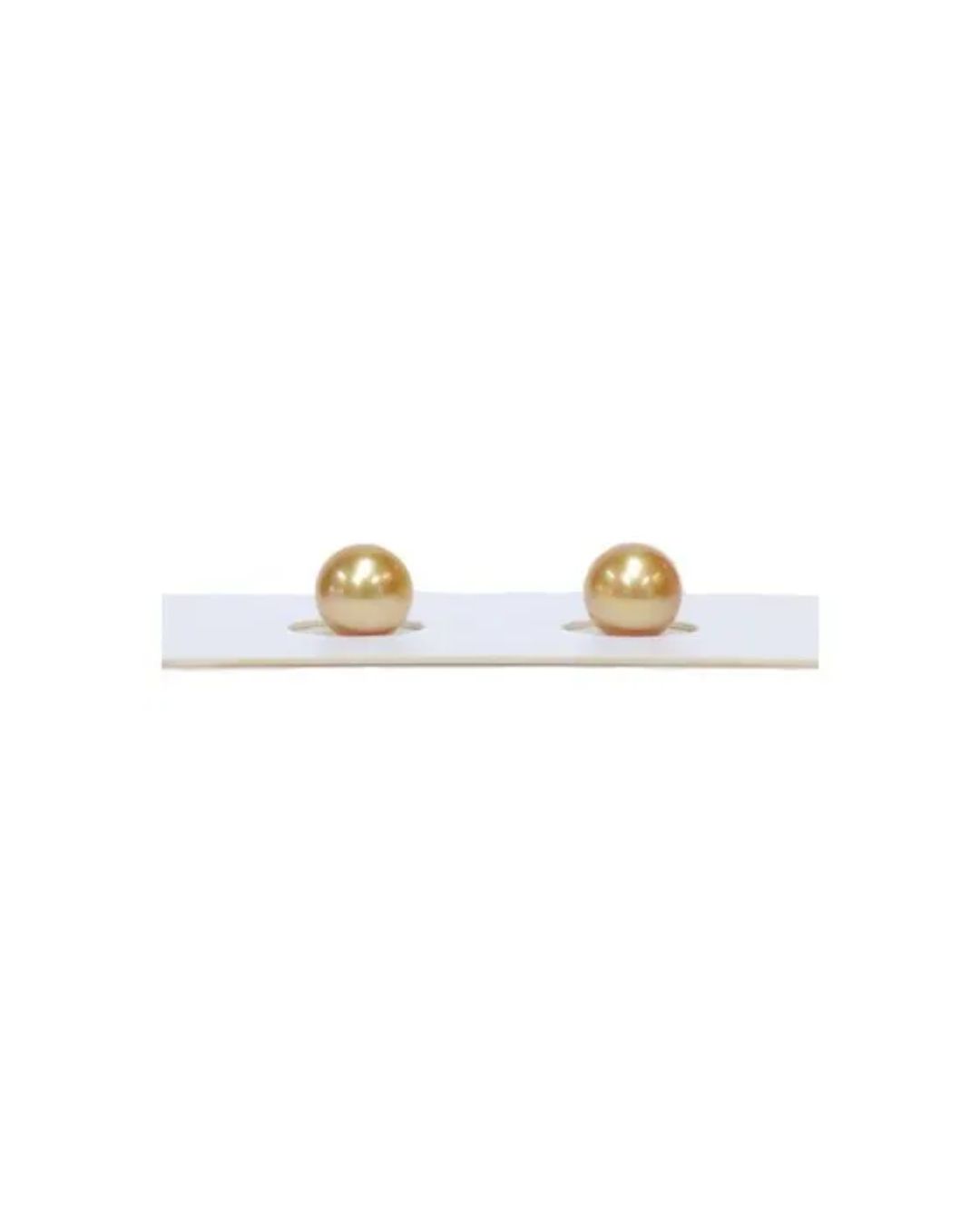 Two round, lustrous golden pearls sit side-by-side in a white display card.