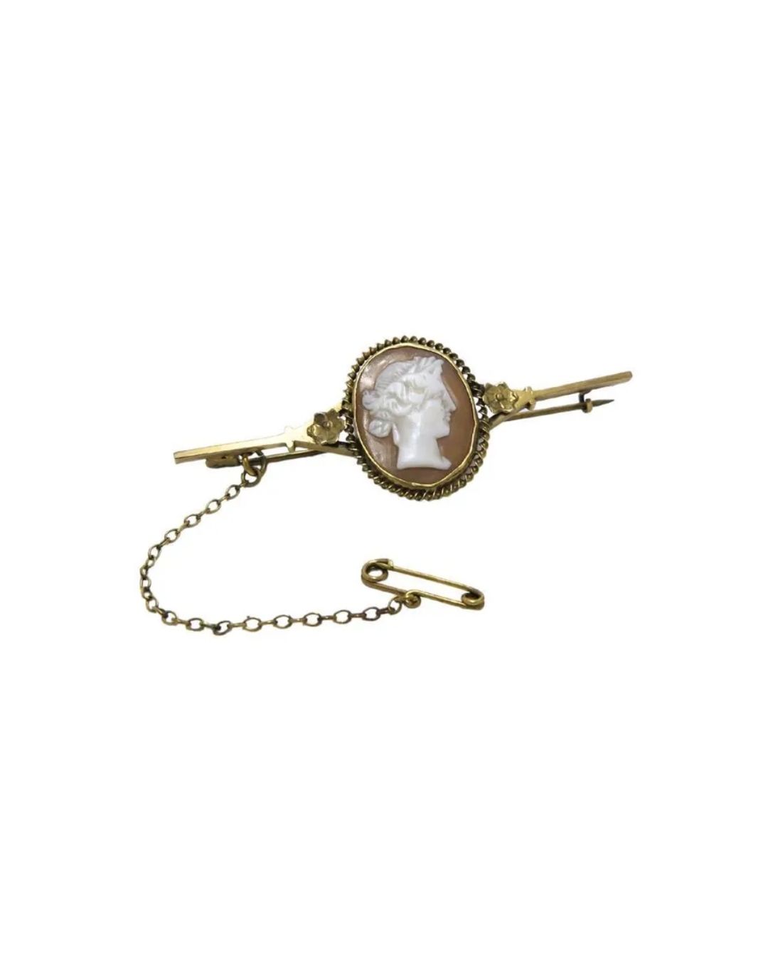 A gold bar brooch featuring a central oval shell cameo of a profile portrait, attached to a safety pin by a thin chain.
