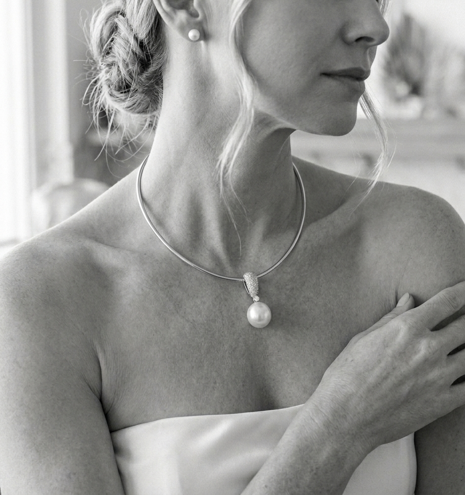 Bride wearing pearl pendant necklace with diamonds on white gold chain