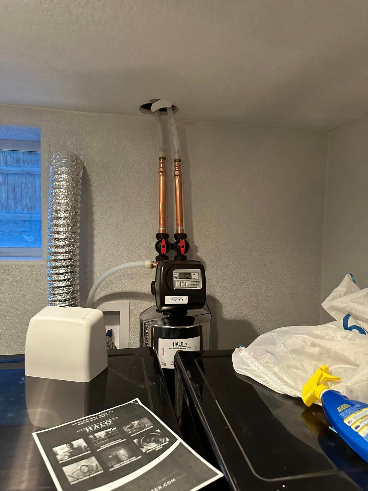 A stove top oven is sitting on top of a counter in a room next to a window.