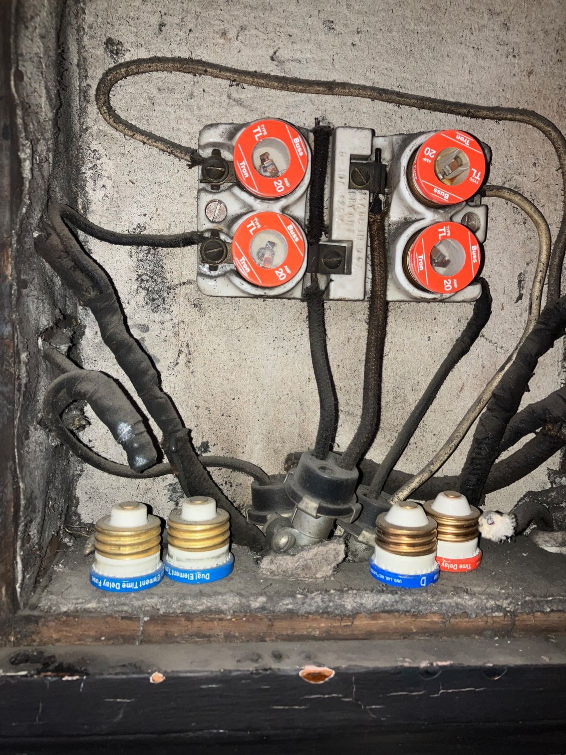 A bunch of electrical wires are connected to a wall.