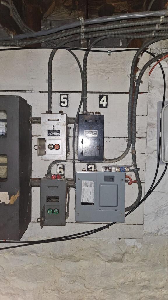 A bunch of wires are connected to a wall.