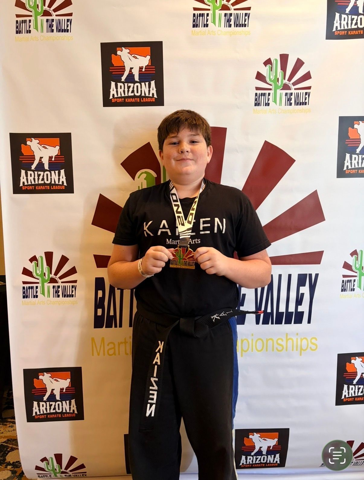 Children ages 7 to 12 practicing Champions Program karate techniques with an instructor at Kaizen Academy in Gilbert, Arizona.