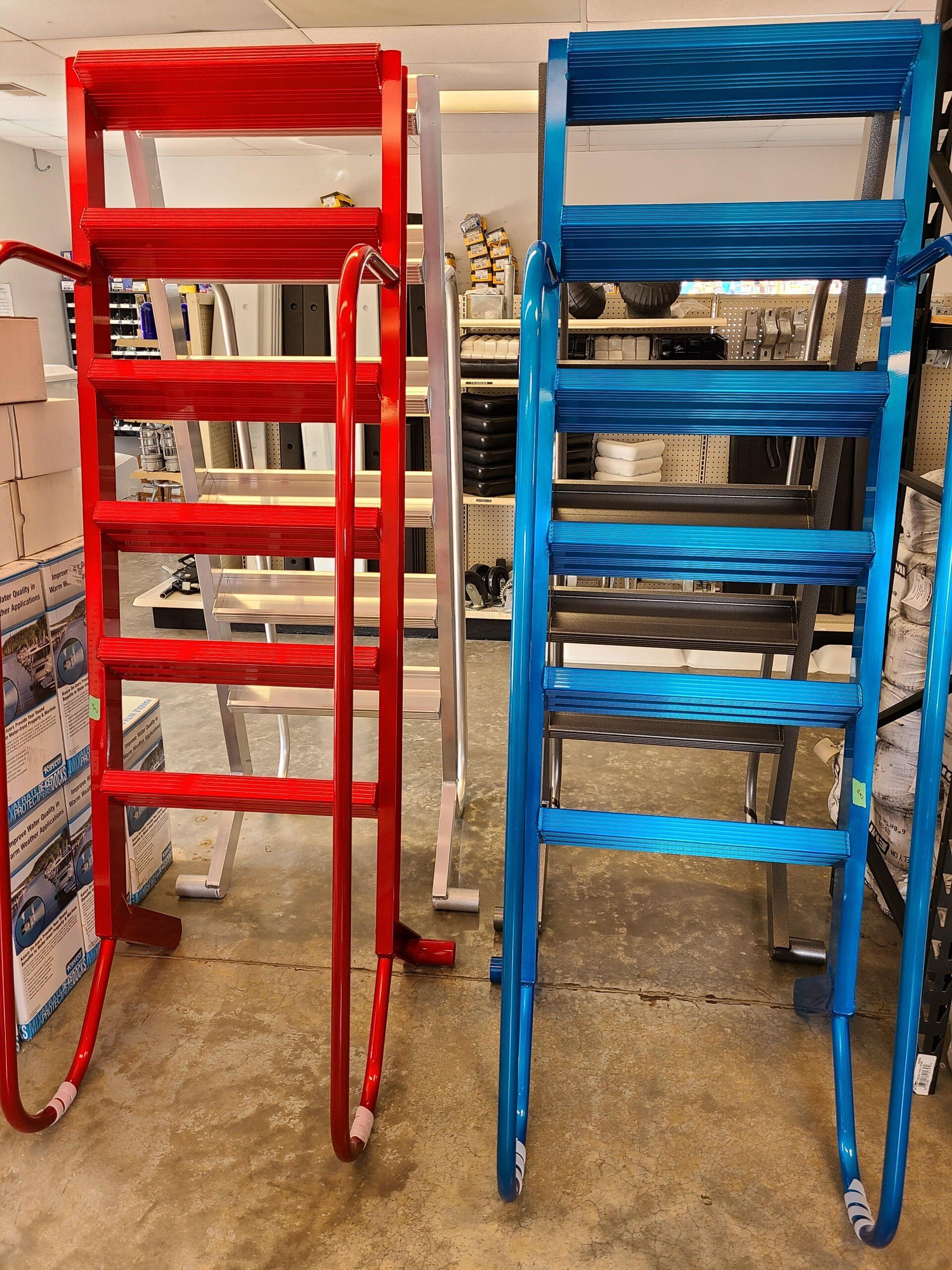 Red and blue metal rolling shelves stacked with items in a workshop or storage area