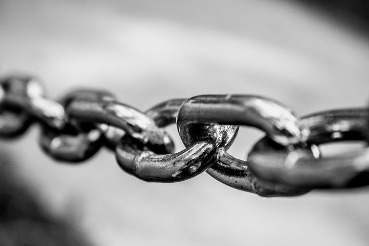 Close-up black-and-white photo of interlinked metal chain links
