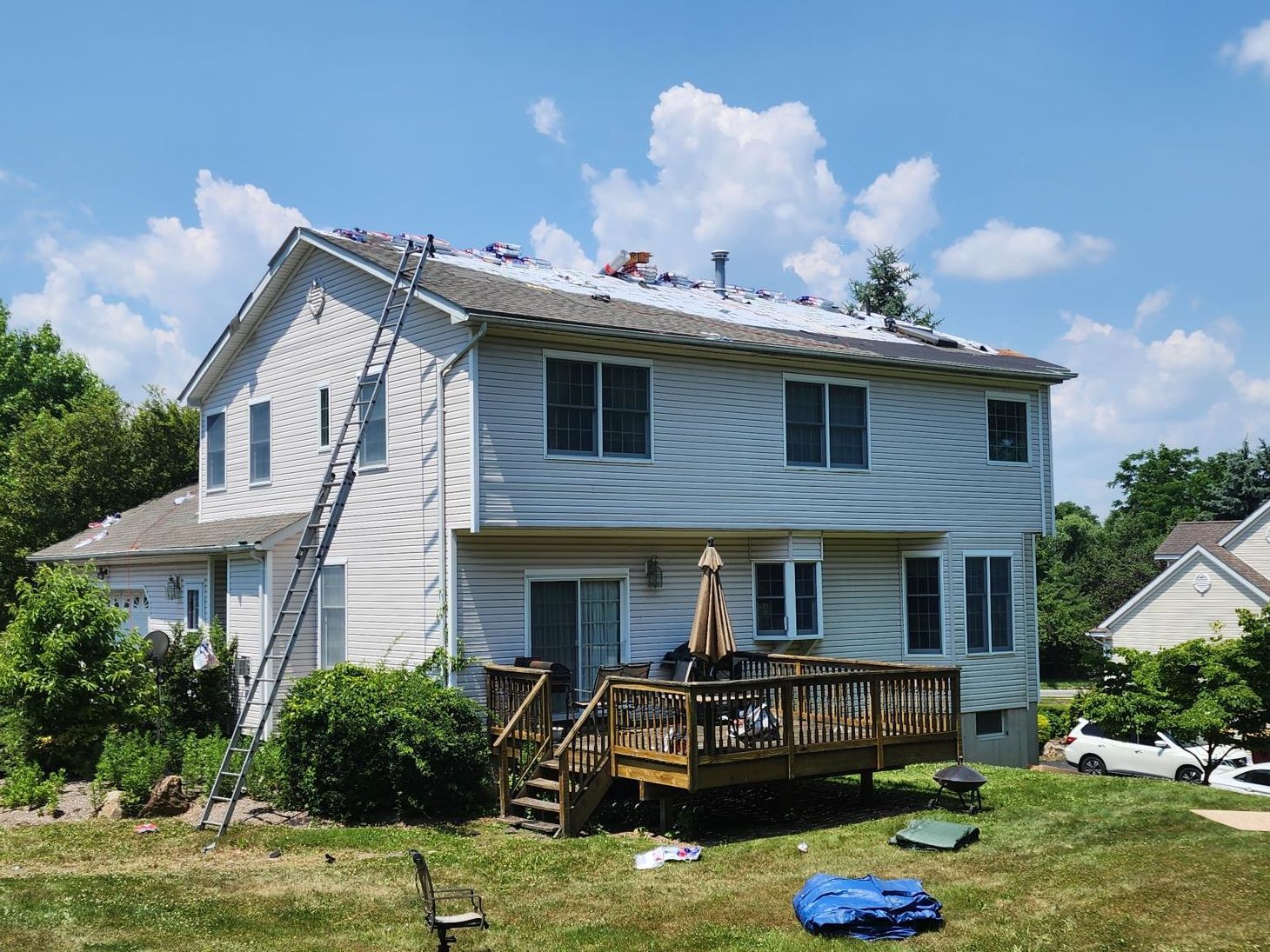 A skilled roofer diligently constructing the roof framework at a bustling building site.
