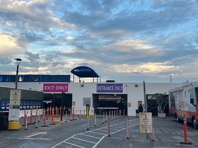 Entrance and exit to an event. Signs say