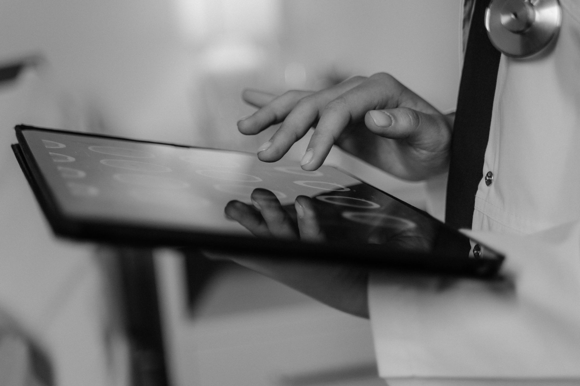 A medical professional holding a laptop computer. 