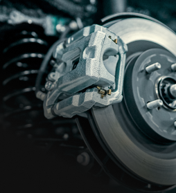 Close-up of a car's disc brake and silver caliper on a wheel assembly | E&R Automotive